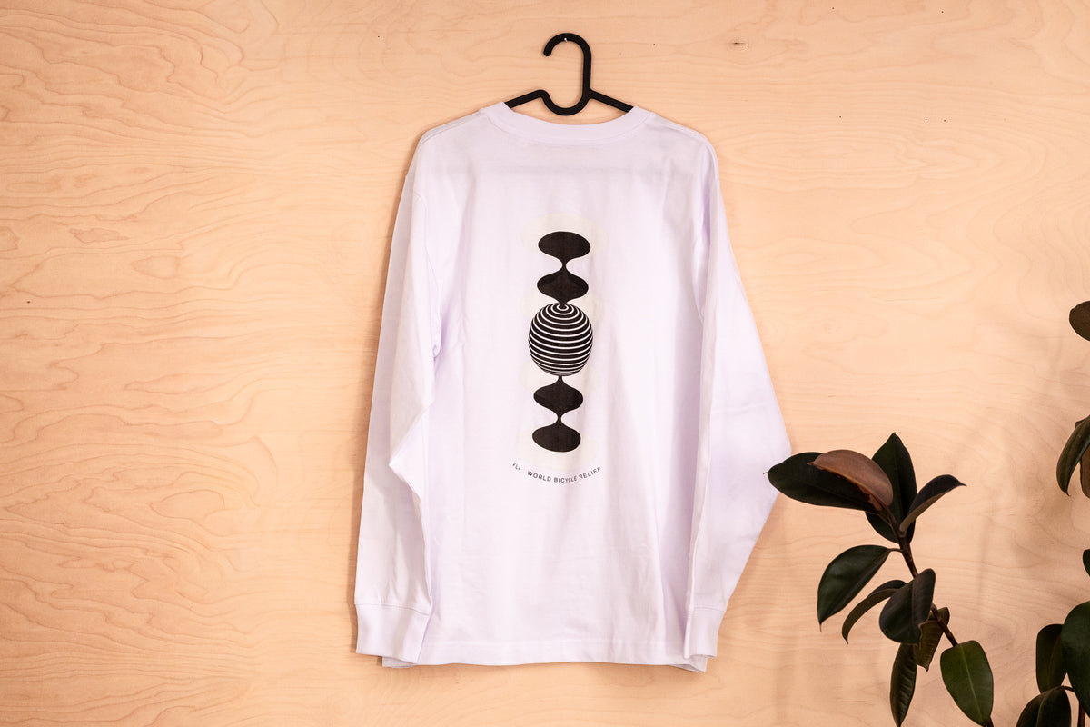 A white long-sleeve t-shirt hanging on a black hanger against a light wood panel background, featuring a black graphic of stacked geometric shapes on the front. With lettering FLi 4 Wordl Bicycle Relief