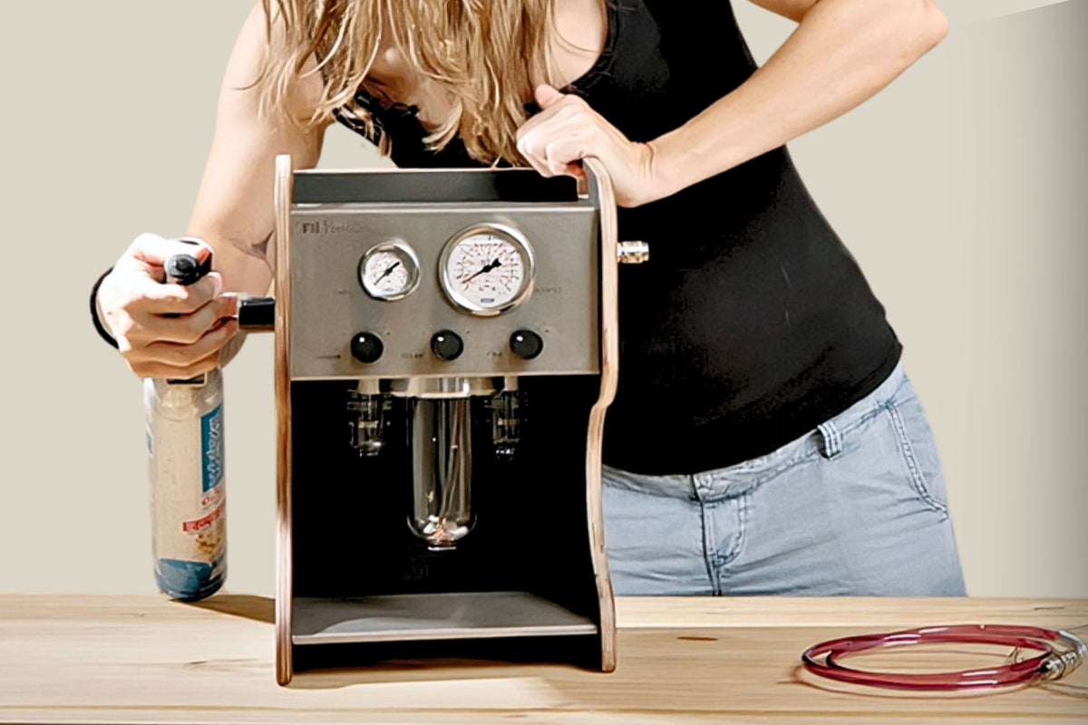 Person showing how to attach CO2 Adapter to Vacuum pump that with a neutral background