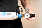Person showing how to screw pressure adapter on a CO2 bottle for the FLI Venturi