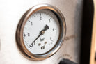 Close-up of the output pressure gauge showing -0.9 bar vacuum on the FLI VENTURI suspension bleeder