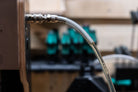 Close-up of a hose during suspension bleeding with a blurred background