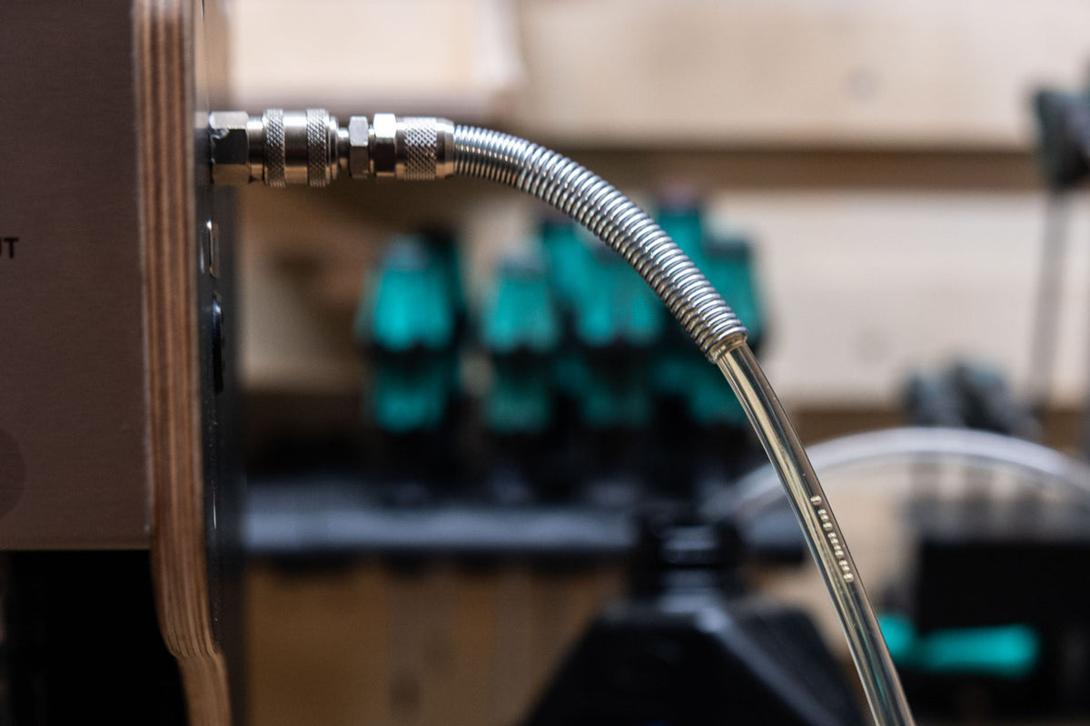 Close-up of a hose during suspension bleeding with a blurred background