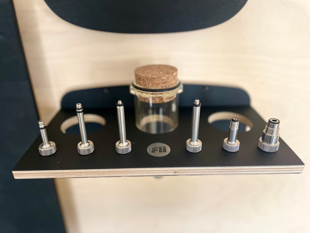 full set of MTB shok adapters in a n elegant hanging wall mount made of black wood